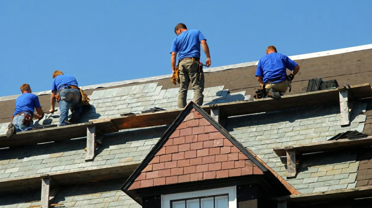 Roof replacement in progress with a team of professional contractors installing new shingles on a residential home in Dallas, TX